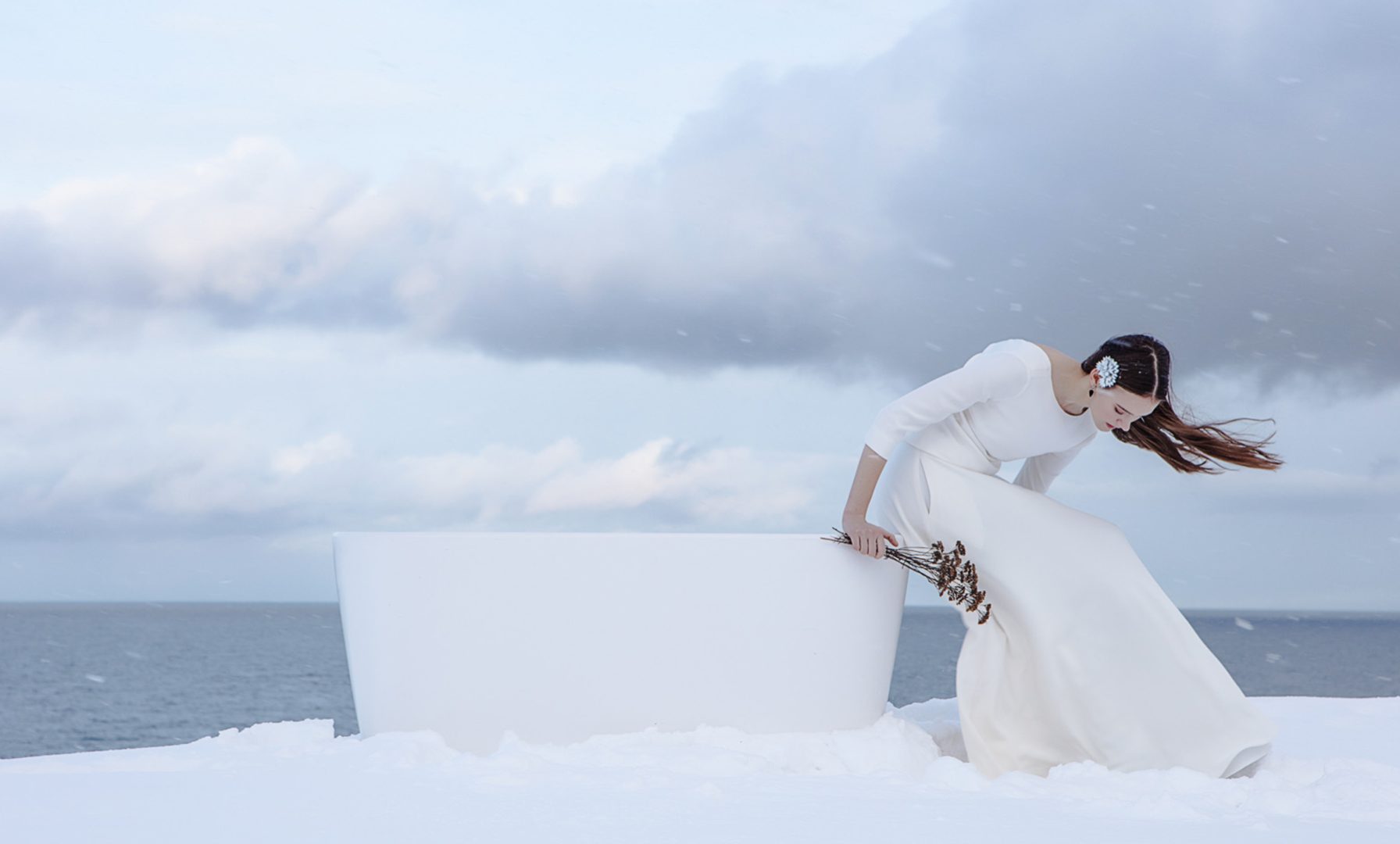 Woman standing on Türisalu cliff with the Azur stone bathtub