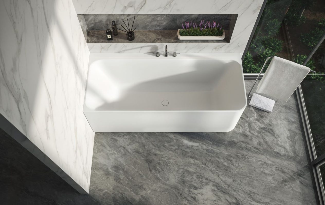 Top view of the Cleo corner-connected bathtub in a bathroom